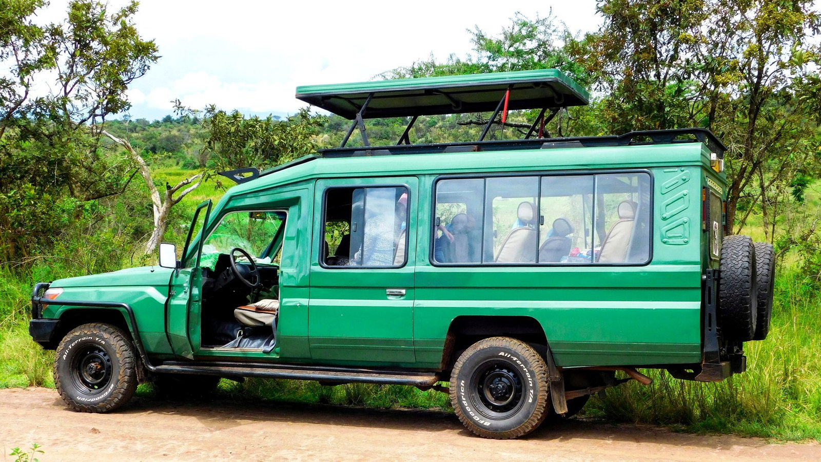Pop-top safari Land Cruiser on a park road